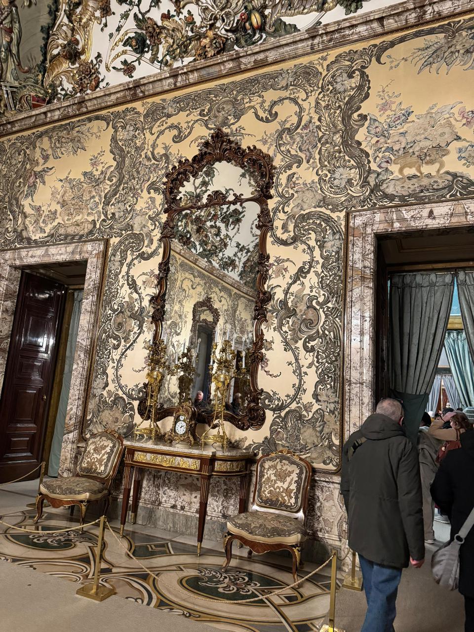 Ornate golden wall panels and antique furniture